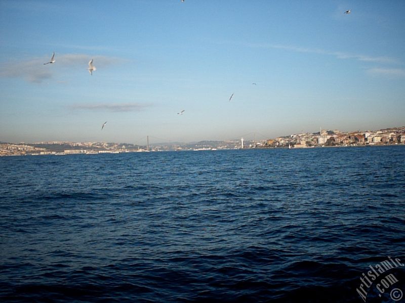 View of Bosphorus Bridge, Uskudar coast and Kiz Kulesi (Maiden`s Tower) from the Bosphorus in Istanbul city of Turkey.
