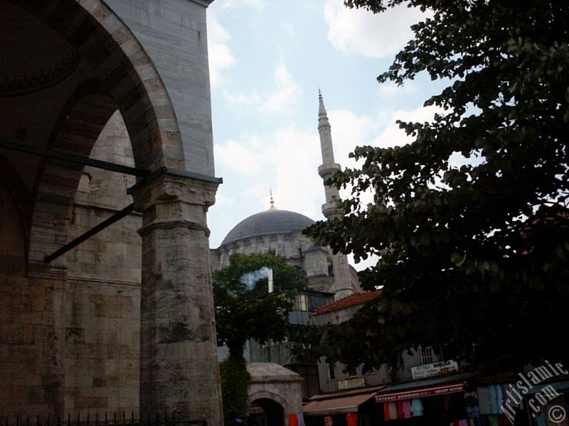 View of Nuruosmaniye Mosque from Mahmut Pasha Mosque`s outside court in Beyazit district in Istanbul city of Turkey.
