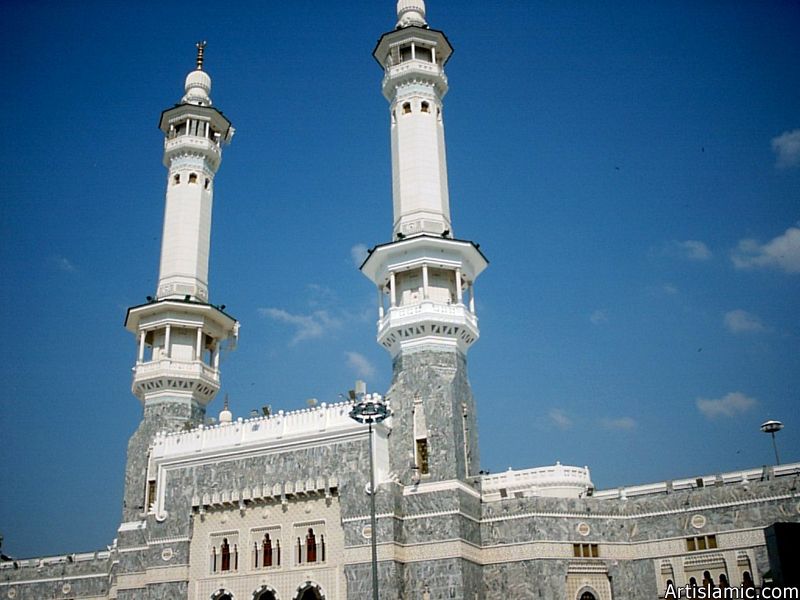 The minarets rising over the walls of the Masjed al-Haraam where is the Holy Kabah located in it.
