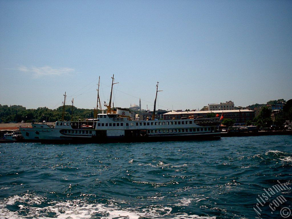 View of Eminonu coast, ships and Ayasofya Mosque (Hagia Sophia) from the sea in Istanbul city of Turkey.
