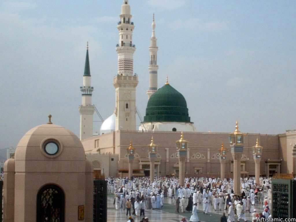 The Prophet Muhammad`s (saaw) Mosque (Masjed an-Nabawe) in Madina city of Saudi Arabia and the muslims going out of mosque after a prayer time.
